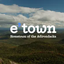 picture of mountains & our e'town logo with hometown of the adirondacks & blueberry logo
